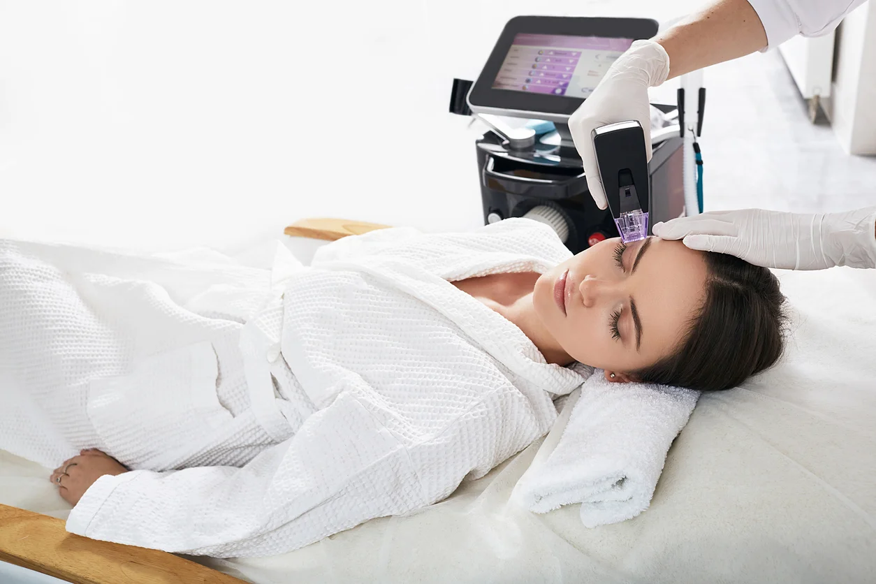 Clinician performing Morpheus8 radiofrequency microneedling treatment on patient's forehead at Cross Hudson Plastic Surgery